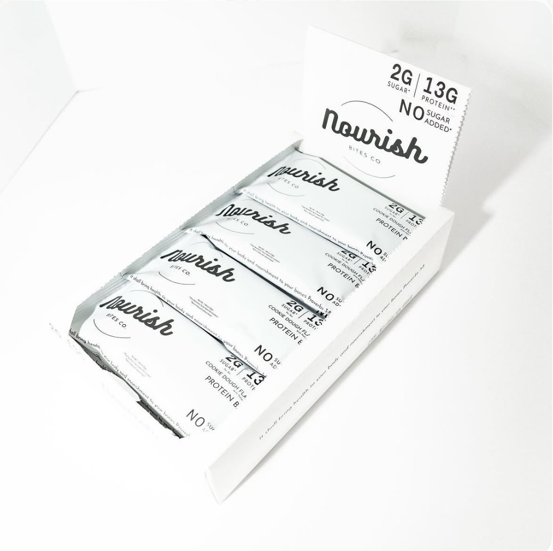 Nourish Bites Co. protein bars in an open display box
